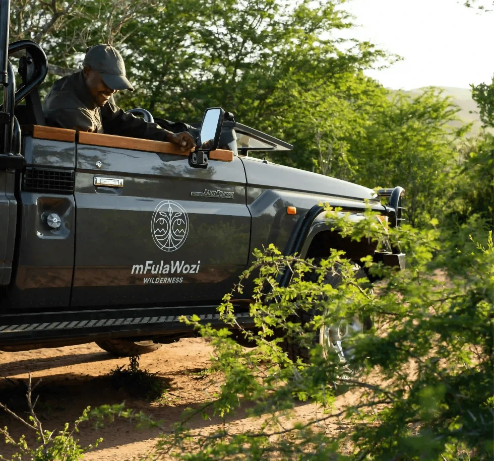 A guide cuts the engine on the embankment of the White iMfolozi River